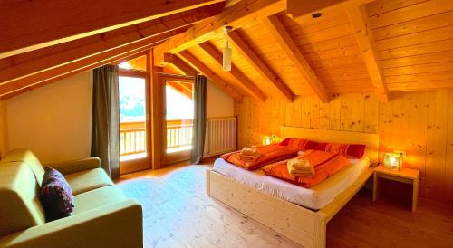 a bedroom with a large bed in a wooden room at Apartment HaNiLe in Sarntal