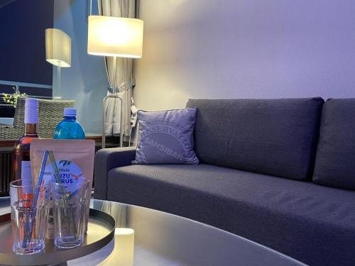 a living room with a couch and a table at Themenpartment Himmel und Mehr Penthouse in Gelsenkirchen
