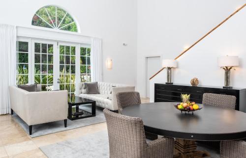 a living room with a table and chairs at Le Soleil D'or in Cayman Brac