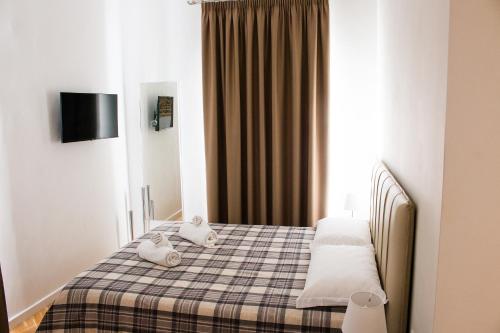 a bedroom with a bed with two stuffed animals on it at BARBAJA SUITES IN STREET TOLEDO 205 in Naples