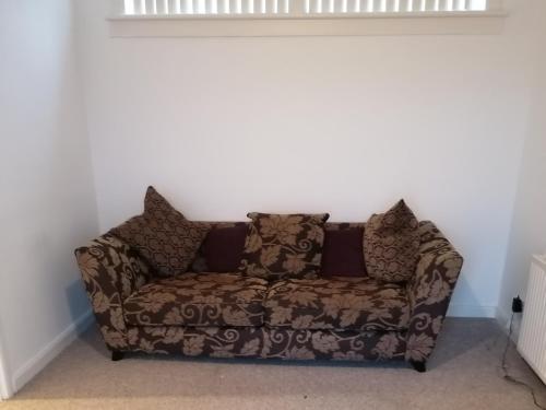 a couch in the corner of a room at Bathgate Handy House in Bathgate