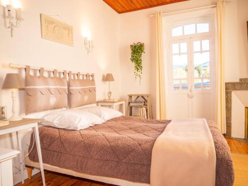 a bedroom with a large bed and a window at Belle maison de montagne in Le Pla
