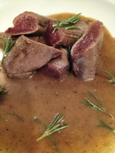 a plate of soup with meat and rosemary on it at Da Erminia in Verdabbio