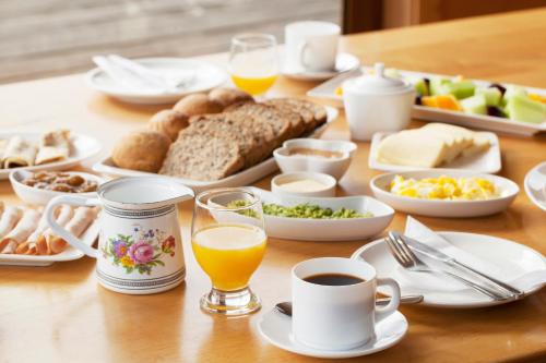 a table with breakfast foods and drinks on it at Palafito 1326 Hotel Boutique Chiloé in Castro