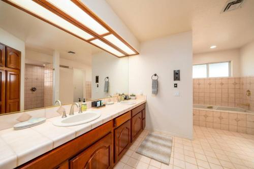a large bathroom with two sinks and a tub at Grand Havasu Oasis with Custom Pool & Spa! in Lake Havasu City