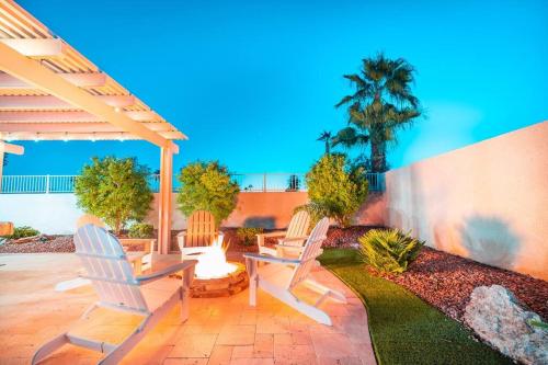 a patio with two chairs and a fire pit at Grand Havasu Oasis with Custom Pool & Spa! in Lake Havasu City