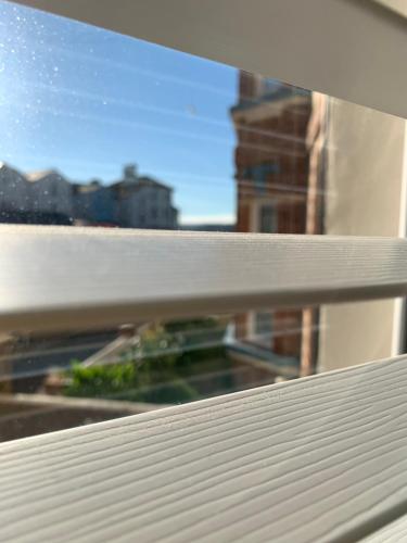 a window with a view of a building at Sandy feet retreat in Exmouth