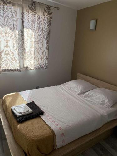a bed in a bedroom with a towel on it at Maison cosy centre de Nîmes in Nîmes