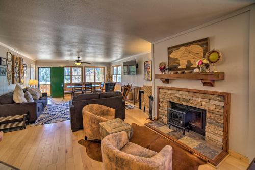 a living room with a fireplace and couches at Red River Condo with Fire Pit half Mi to Slopes! in Red River