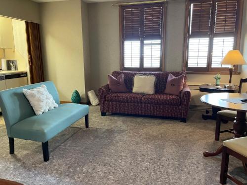 a living room with a couch and a chair at Hotel Phillips in Bartlesville