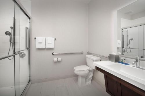 a bathroom with a toilet and a sink and a shower at Holiday Inn Express Puyallup, an IHG Hotel in Puyallup