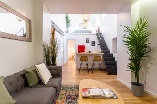 a living room with a couch and a table at Bairro Alto Bronze of Art Apartments in Lisbon