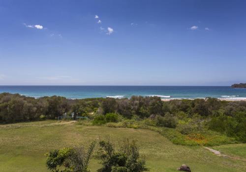 a view of the ocean from a house at Beachfront Paradise - Jones Beach in Minnamurra