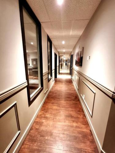 a hallway in a building with a long floor and windows at Cozy Sweet Studio #1, 10 minutes to D.T. Ottawa in Gatineau