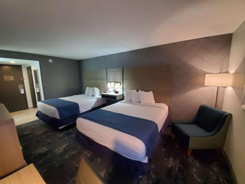 a hotel room with two beds and a chair at Best Western Historic Frederick in Frederick