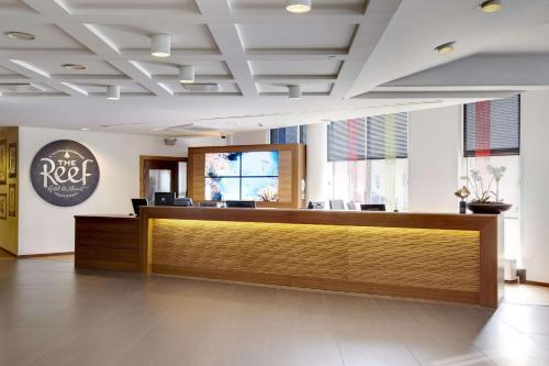 a lobby of a hotel with a reception desk at Scandic The Reef in Frederikshavn