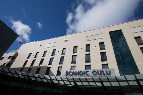 a building with a sign on the side of it at Scandic Oulu City in Oulu