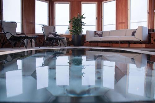 a living room with a pool with chairs and a couch at Scandic Plaza Borås in Borås