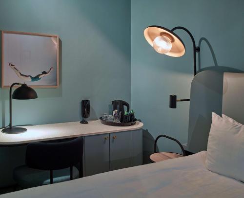 a bedroom with a lamp and a lamp post at Scandic Klara in Stockholm