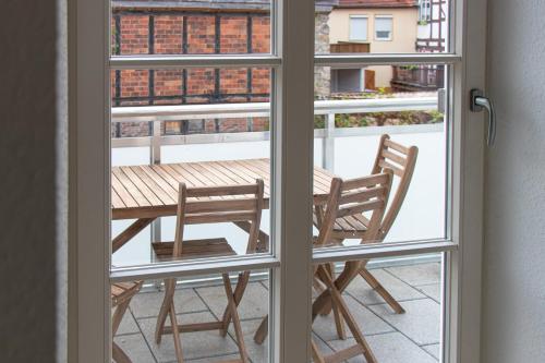 a view of a table and chairs through a window at Ferienwohnungen Galerie im Klink in Quedlinburg