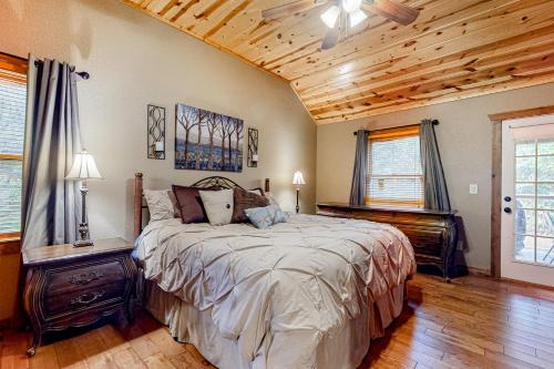 a bedroom with a large bed and a wooden ceiling at Wandering Bear's Den in Ellijay