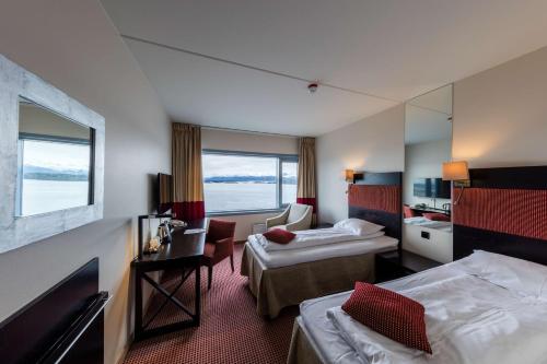 En eller flere senge i et værelse på Scandic Seilet Hotel