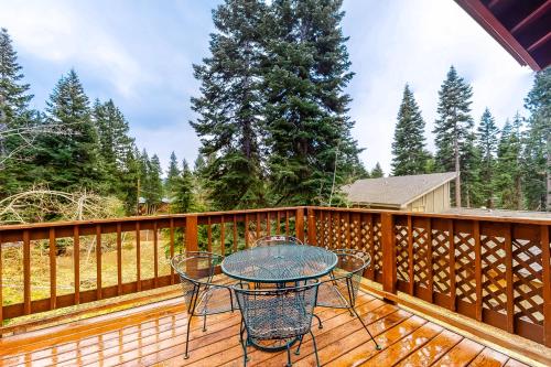 a patio with a table and chairs on a wooden deck at Tahoe's Stunner in Tahoe Vista