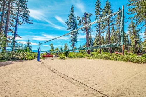a volleyball court with a bench and a net at Tahoe's Stunner in Tahoe Vista