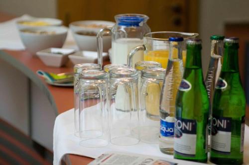 a table with glasses and bottles of beer on it at Hotel Merlot in Louny