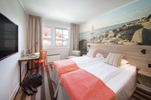クリスティアンサンにあるScandic Sørlandetの大きなベッドが備わる客室で、壁に絵画が飾られています。