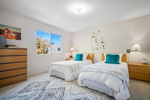 a bedroom with two beds and a dresser at Canyon Wind Casita in Moab