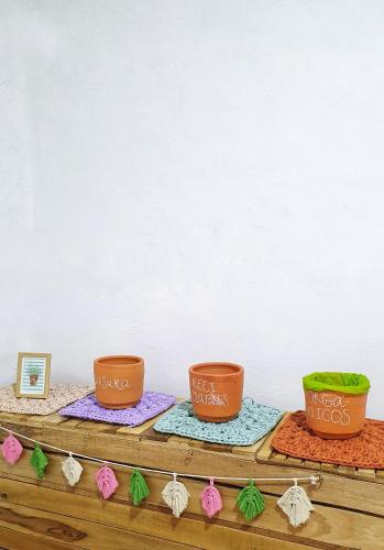 a group of four pots sitting on top of a table at La Casona Espacio Bonito in Zapatoca