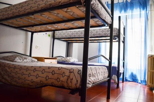 A bed or beds in a room at Roomin Hostel