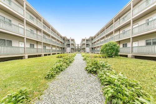 an empty courtyard of an apartment building with plants at Pinnacle in Beech Mountain
