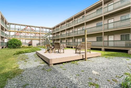 a building with chairs and tables in front of it at Pinnacle in Beech Mountain