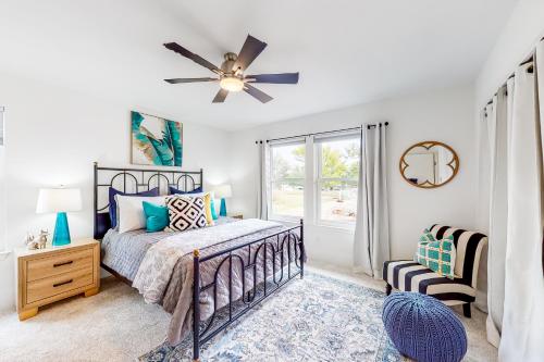 a bedroom with a bed and a ceiling fan at Lago Vista Sunset Villa in Lago Vista