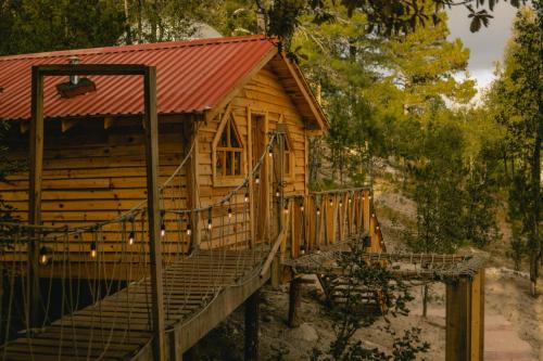 a wooden cabin with a staircase leading up to it at Wooden Inn - Cabañas Boutique y Bubble Glamping en Creel in Creel