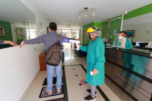 a couple of people standing at a bowling alley at HOSTAL CORAL in Ilo