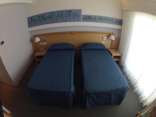a room with two blue seats in a plane at City Hotel in Senigallia