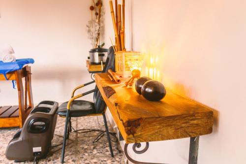 a wooden table with a chair in a room at Casa de Campo Hotel & Spa in Villa de Leyva
