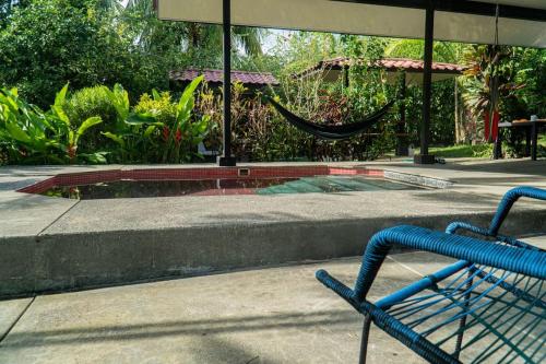 a hammock sitting in front of a swimming pool at Pool house, Casa Luna in Pavones