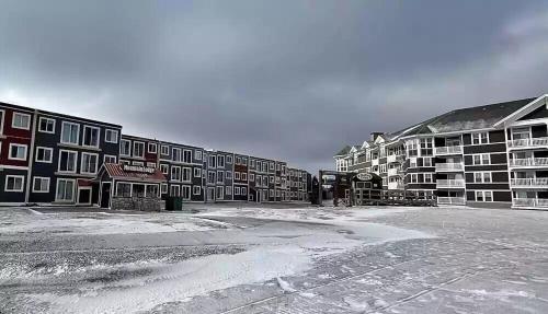 a group of apartment buildings with snow on the ground at Enjoy the Long Range View, Ski in n out Top of the Mountain condo in Snowshoe