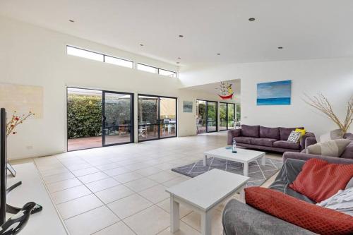 a living room with couches and a table at Sea Haven: coastal views, family retreat in McCrae