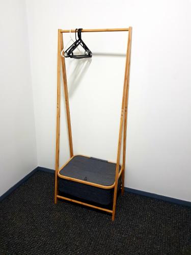 a wooden shelf with a black cushion on a wall at Criterion Hotel Grenfell in Grenfell