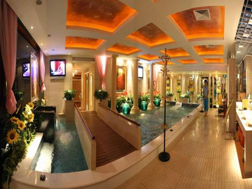 a lobby of a building with potted plants at Shenzhen Kaili Hotel, Guomao Shopping Mall in Shenzhen