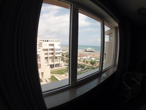 a window view of the ocean from a building at City Hotel in Senigallia