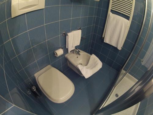 a small bathroom with a toilet and a sink at City Hotel in Senigallia