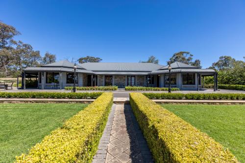 a building with a garden in front of it at Benbullen Retreat in Angaston