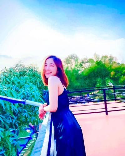 a woman in a blue dress standing on a bridge at บ้านเดอะเมาเท่น By The Mountain Ozoneบ้านโอโซนขุนเขาแก่งกระจาน in Ban Song Phi Nong