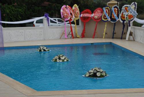 a swimming pool with rocks in the water at Funda Hotel in Göcek
